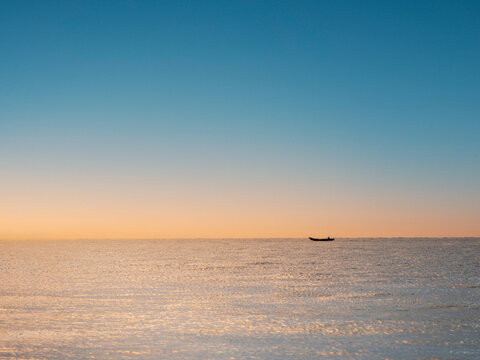 Blue Solitude: A Lonely Boat on the Open Sea