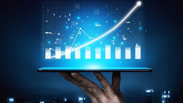 A hand holds a tablet displaying a digital graph with a rising trend, representing growth in business analytics and data visualization technology in a dynamic environment. Copula