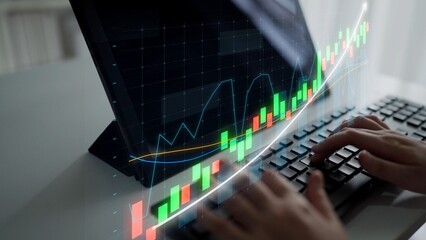 Engaging image of a person typing on a keyboard with a computer screen showing vibrant financial...