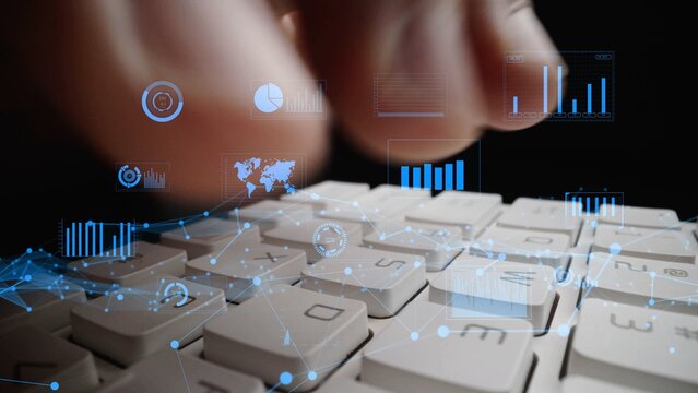 A close-up shot of hands typing on a keyboard with a digital overlay displaying data visualizations and analytics, showcasing modern technology in action. Xenic