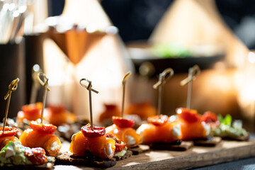 Pumpernickel bread sandwich snack with cured smoked salmon and fresh avocado served as close-up on a wooden cutting board