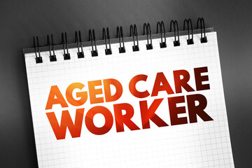 Fototapeta premium Aged care worker - provides personal, physical and emotional support to older people who require assistance with daily living, text on notepad