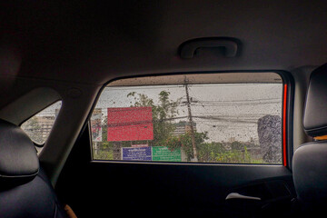 View from the inside of a working car,Car traffic jam,illuminated road during heavy rain and thunderstorms,highways in big cities,Rain drops on the car glass.