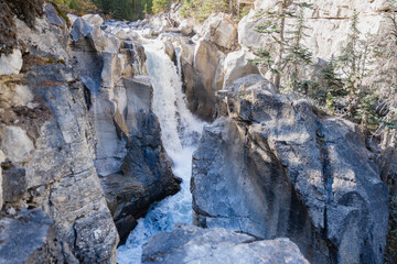 Waterfalls Spilling Through Jagged Granite Rocks in the Wilderness of Banff, Alberta