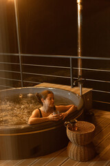 Relaxing evening in a hot tub on a balcony at night