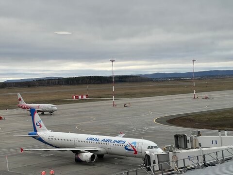 Samara Kurumoch Airport, Russia, November 9, 2025: A Ural Airlines plane in the foreground and a Russia plane in the background before being refueled