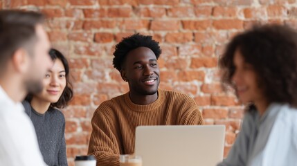 Business collaboration scene featuring a smiling African American man in a trendy workspace, surrounded by diverse colleagues engaged in discussion and teamwork