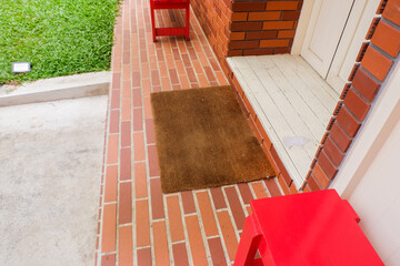 Welcome mat on red brick floor,Overhead of blank doormat at the front door,office or home,space for text.
