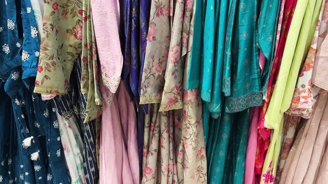 colorful women&rsquo;s ethnic kurtis displayed on clothing rack in fashion store