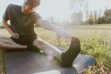 Young man stretching outdoors on an autumn afternoon in udine