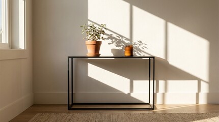 Plant and candle on a console table in sunlight room