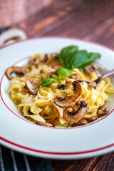 Tagliatelle pasta with  parmesan and mushrooms 