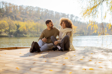 Fototapeta premium Enjoying a sunny afternoon by the water with laughter and warmth