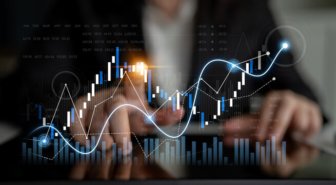 A professional setting showcasing financial growth through digital graphs and charts. The image captures hands analyzing data on a screen, illustrating trends and performance metrics. Scalp