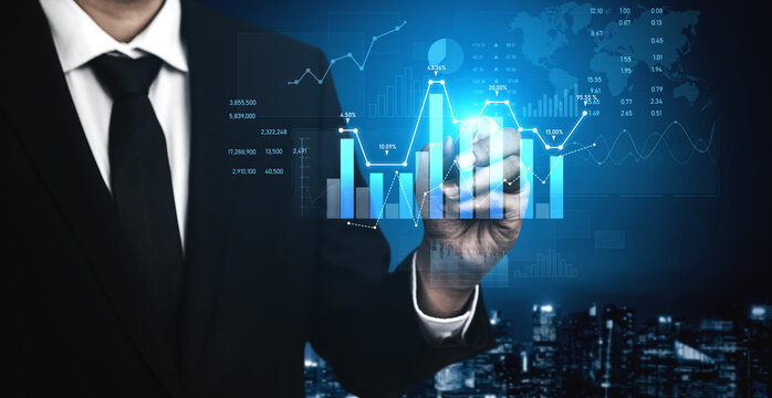 A business professional interacts with digital graphs and data visualizations in a sleek urban environment. Explore insights in finance and technology. Scalp