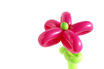 A flower made of balloons stands on a white background.