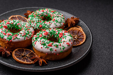 Christmas donuts or doughnuts, holiday winter sweets with sprinkles. Christmas donuts