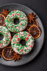 Christmas donuts or doughnuts, holiday winter sweets with sprinkles. Christmas donuts