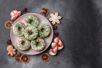 Christmas donuts or doughnuts, holiday winter sweets with sprinkles. Christmas donuts