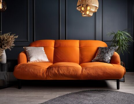 interior features vibrant orange sofa against a dark elegant background