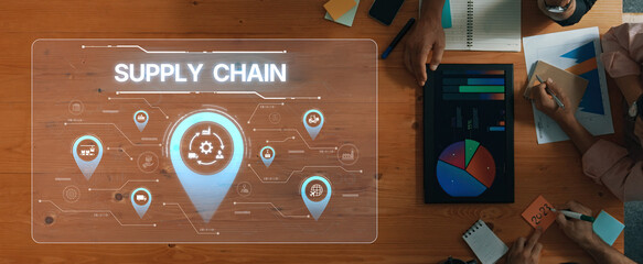 A modern workspace shows a supply chain management concept with digital visuals and analytics tools. Business teams use collaboration to enhance strategies and performance. Trope