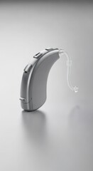 Modern digital hearing aid device on a white background for hearing loss treatment and medical technology advertisement