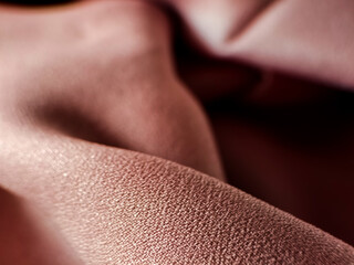 pink fabric with a textured surface, featuring a shimmering effect. 