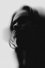 Beautiful young woman sensual portrait. Model illuminated with back light and visible silhouettes....