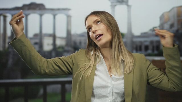Woman gesturing passionately with hands in front of ancient roman ruins, showcasing a lively discussion amidst the historical backdrop of an outdoor city setting.