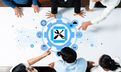 A diverse team of professionals analyzing and discussing a digital strategy, with technology icons displayed on a table, symbolizing collaboration and innovation. Trope