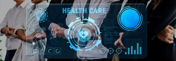 A professional team stands together with a digital health care interface in view, showcasing data visualization and technology role in modern healthcare environments. Trope