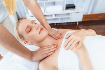 Obraz premium Caucasian woman customer enjoying relaxing anti-stress spa massage and pampering with beauty skin recreation leisure in day light ambient salon spa at luxury resort or hotel. Quiescent