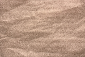 Versatile beige plastic background with soft folds providing a neutral textured surface ideal for product mockups, graphic design layouts, packaging concepts and editable compositions