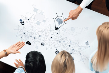 A diverse group engaged in a brainstorming session to foster innovative ideas, surrounded by...