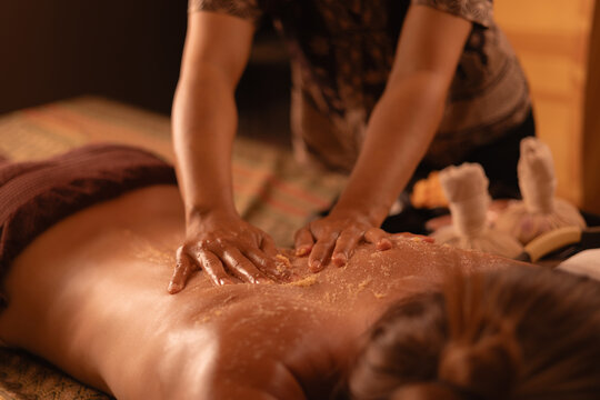 Thai massage therapy session with relaxing techniques and herbal mango skin scrub