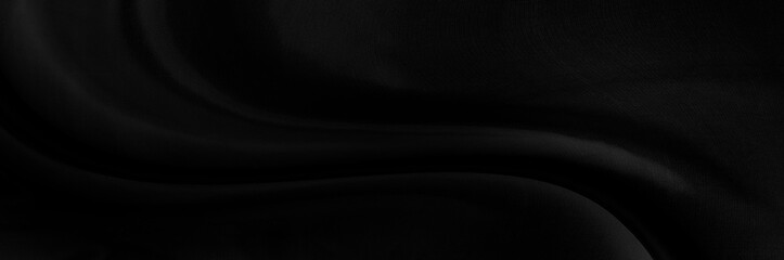 Black gray satin dark fabric texture luxurious shiny that is abstract silk cloth panorama background with patterns soft waves blur beautiful.