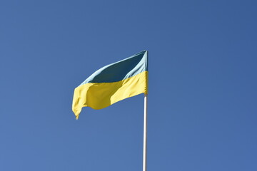 Ukrainian flag against a blue sky. Symbol of national pride and freedom.
