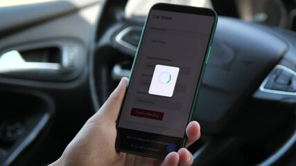 Closeup of a mans hands in a parked car using a mobile app to book a car wash service. The complete process from reviewing service packages and prices to confirming the booking and receiving a success