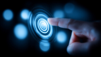 A human finger touching a glowing blue interface represents haptic response, user interaction and futuristic digital control systems.
