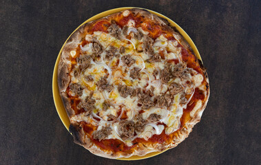 Tuna and onion pizza on yellow plate