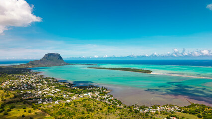 Stunning aerial view of tropical coastal town with turquoise lagoon waters surrounding distinctive...