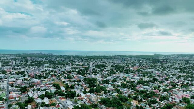 Aerial drone footage of Ponce, Puerto Rico, showcasing the city&rsquo;s colorful colonial architecture, central plazas and coastal landscape from above. Smooth flight movement and clear Caribbean light high