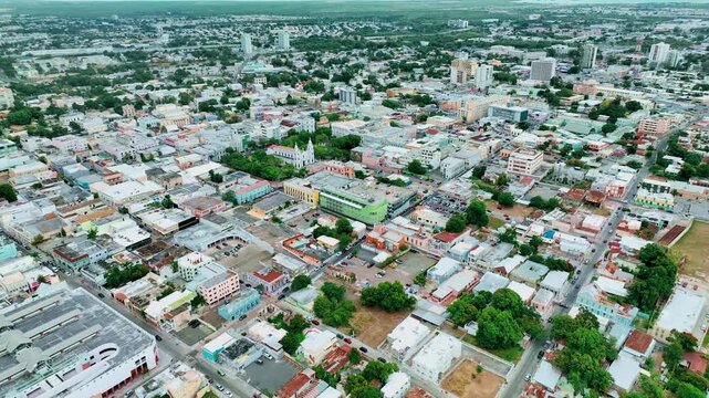 Aerial drone footage of Ponce, Puerto Rico, showcasing the city&rsquo;s colorful colonial architecture, central plazas and coastal landscape from above. Smooth flight movement and clear Caribbean light high