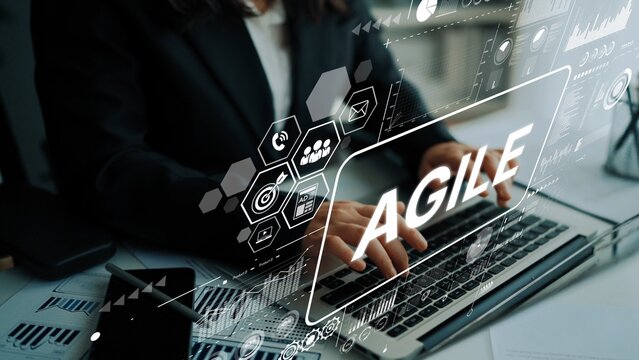 Business Professional Using Laptop with Agile Concept and Digital Interface Overlays in Modern Office Environment. Asymptotic smart data analytic.