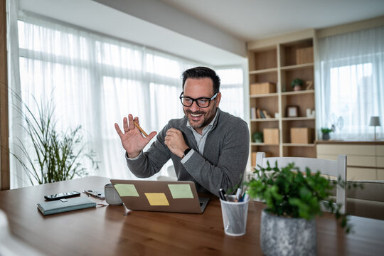 Businessman smiling during video call, working from home - Powered by Adobe