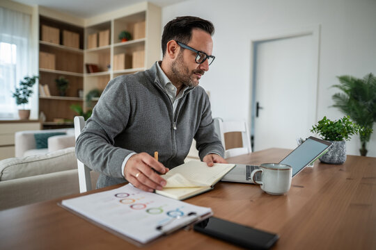 Man working from home managing his business finances