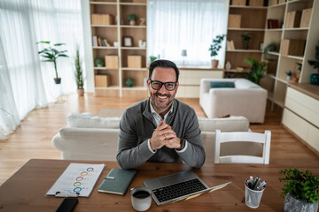 Smiling man working from home at desk