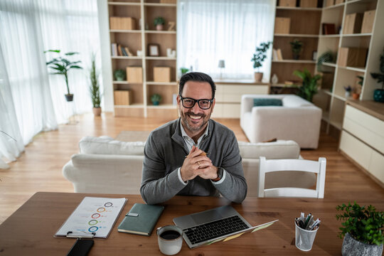 Smiling man working from home at desk