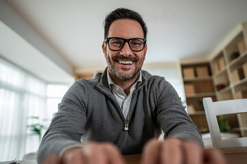Smiling man having video call during teleworking