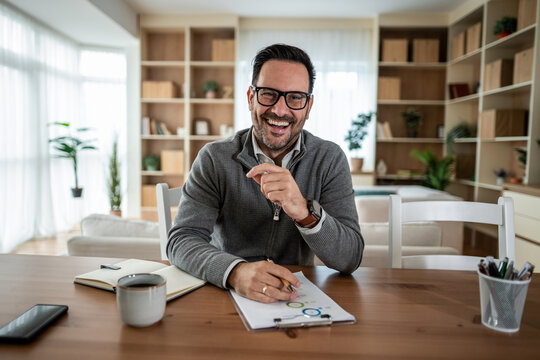 Happy man laughing while working from home